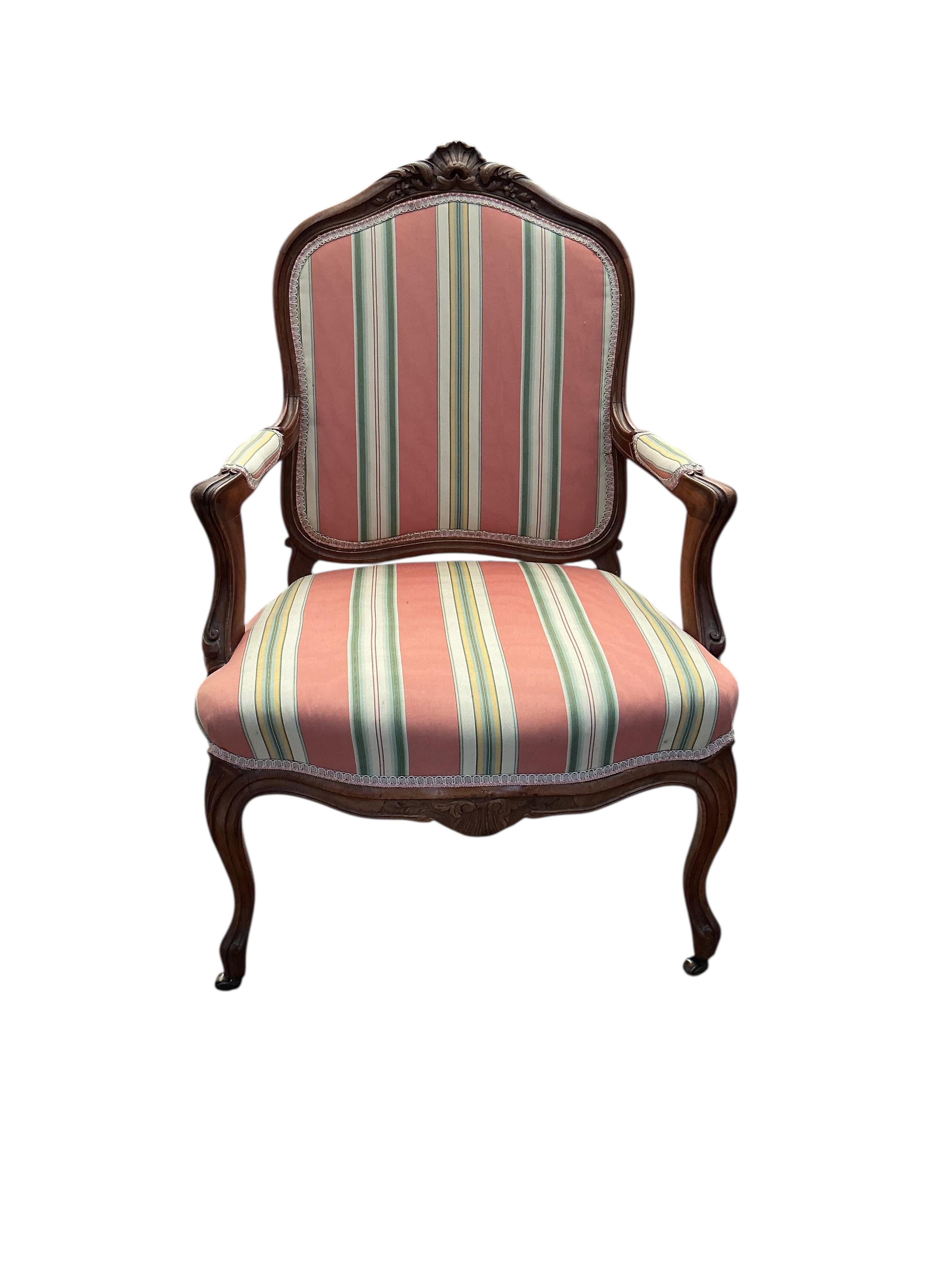 A reproduction Louis XV style walnut upholstered fauteuil, width 66cm, depth 52cm, height 98cm